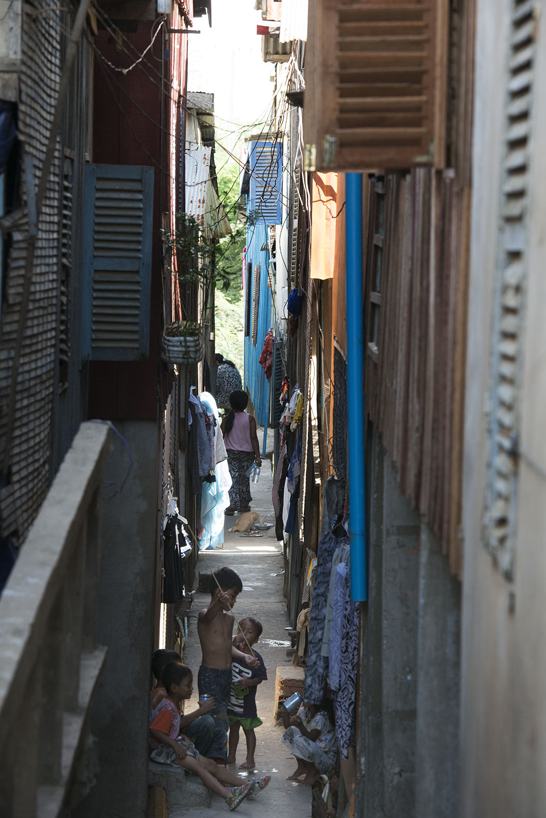 Children playing on the space between the houses, in a narrow alley in Phnom Penh, Cambodia