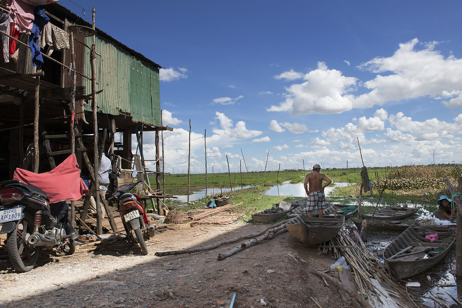 This is a farmer and his home, inside Phnom Penh, Cambodia. His future is not good since the government is reclaiming the land and try to expand the city.