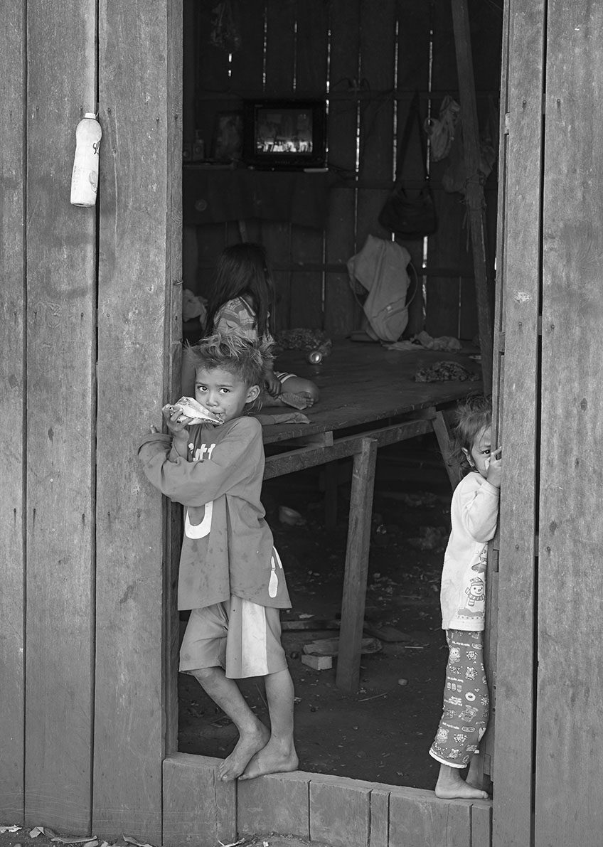 This children lives in a small wooden house with dirt floor together with the entire family, their parents are factory workers in the nearby factory.